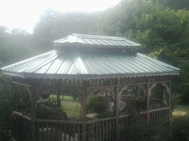 Two tier green metal roof on a garden gazebo in Cleveland